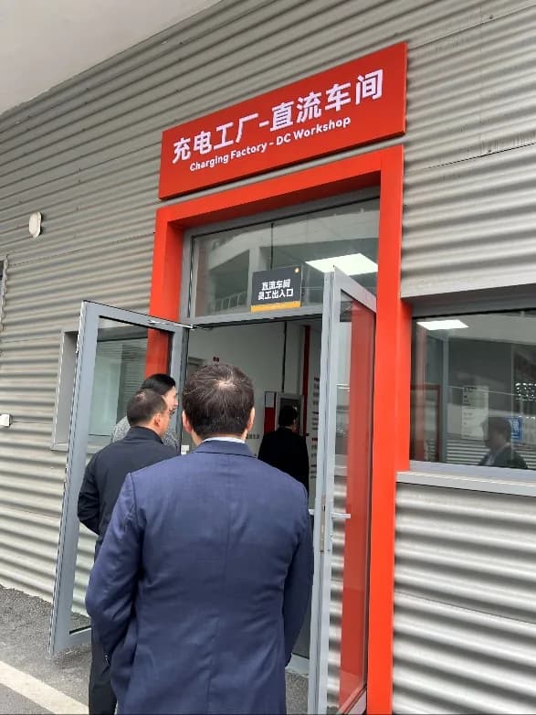 Visitors entering the DC charger workshop at a StarCharge factory