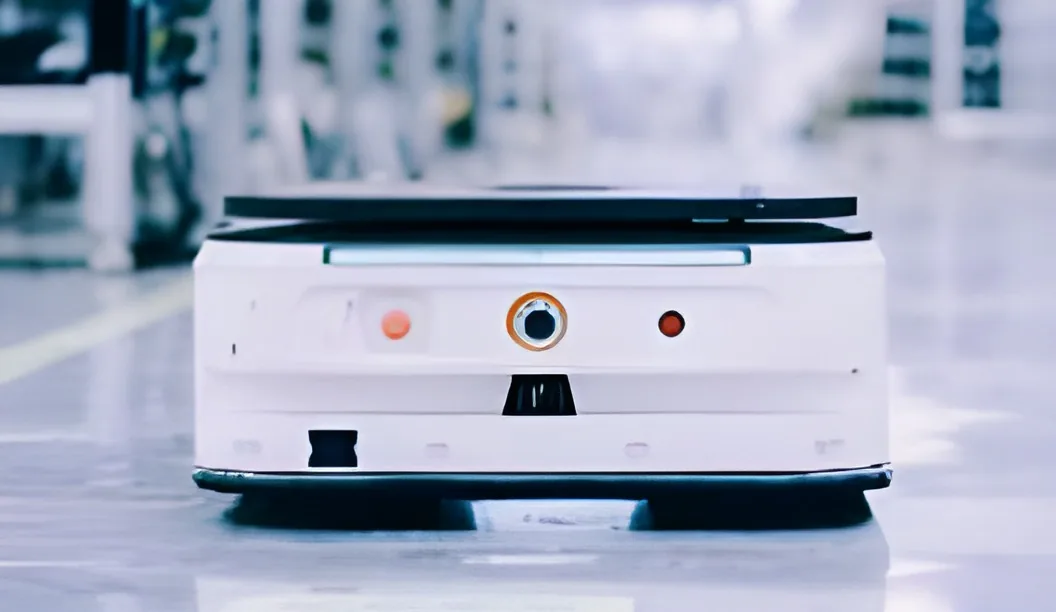 A self-driving cart carrying parts across the factory floor