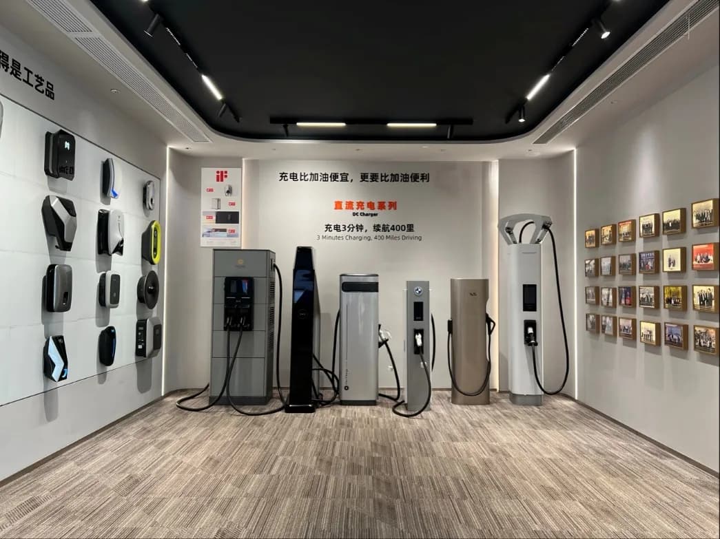 StarCharge's charger showroom, with AC wallboxes on the wall and DC chargers along the floor